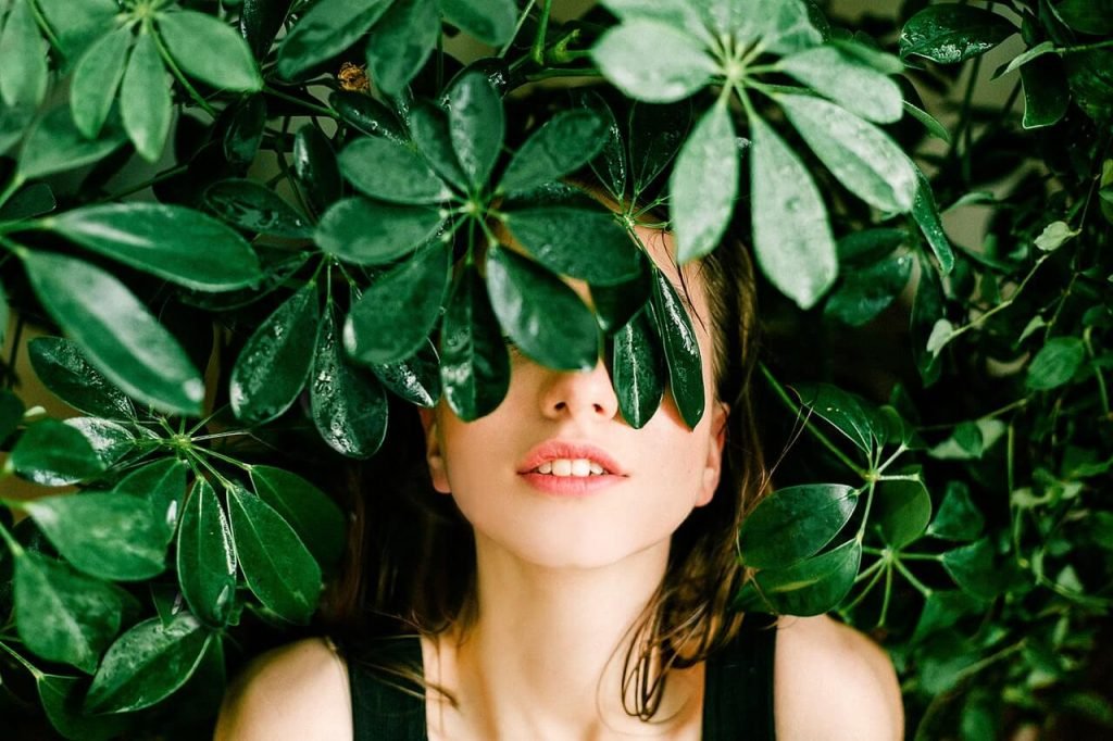 lady lying down under large bush Garden Maintenance
